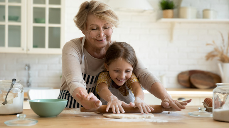 People rolling out dough