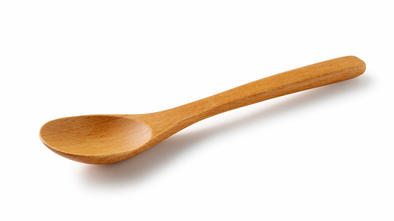 Wooden spoon on white background