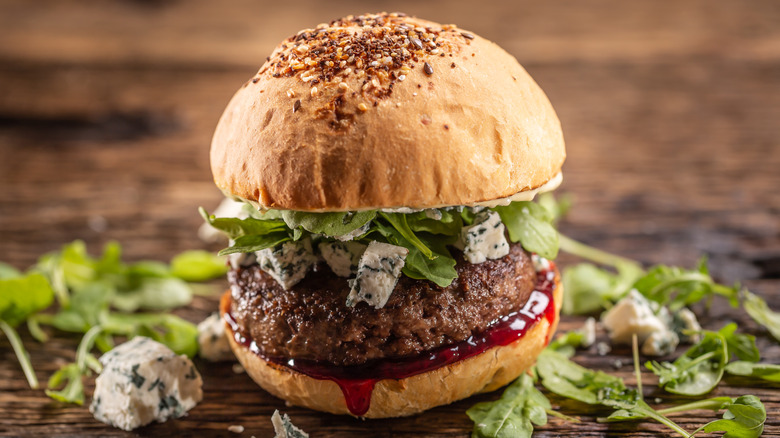 A burger with blue cheese and arugula