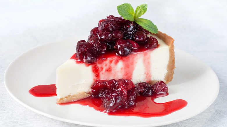 slice of cheesecake topped with cherry pie filling