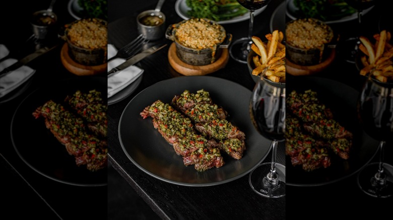 steak with chimichurri sauce wine and chips