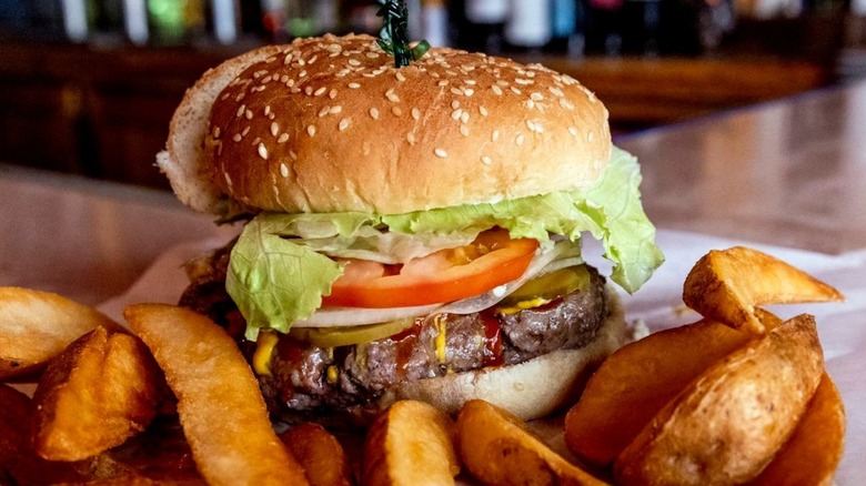Torch Bar and Grill burger with fries on top of bar