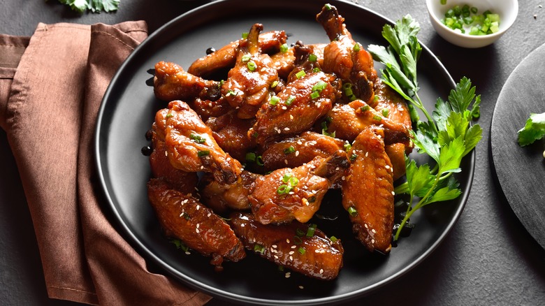 plate of chicken wings with garnish