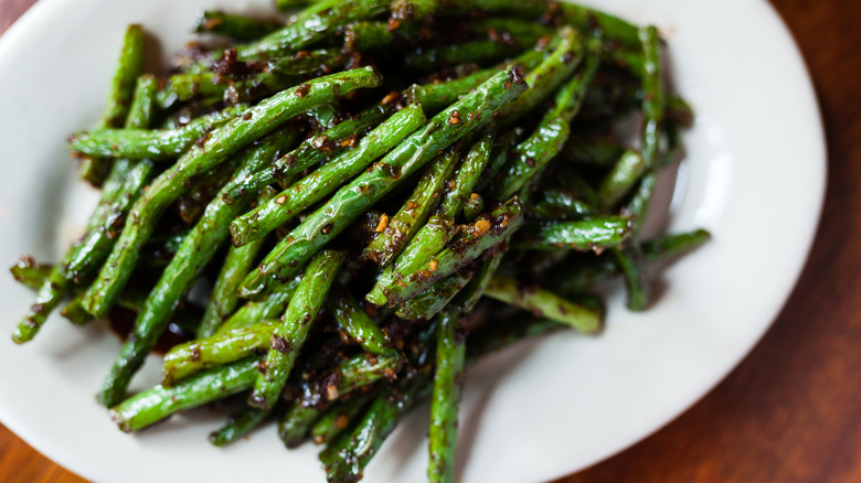 Sauteed green beans on white plate