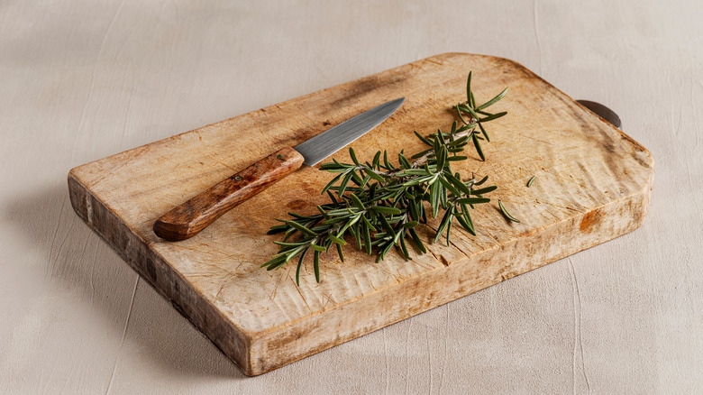 Rosemary sprigs on wood board