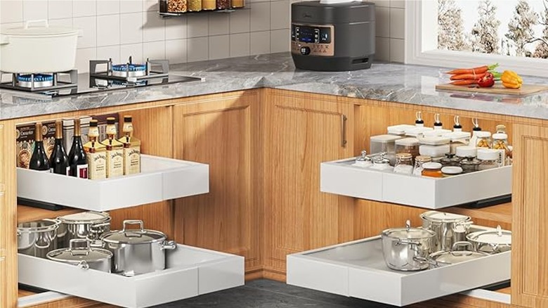 Pull out drawers holding spices, drinks, and cookware