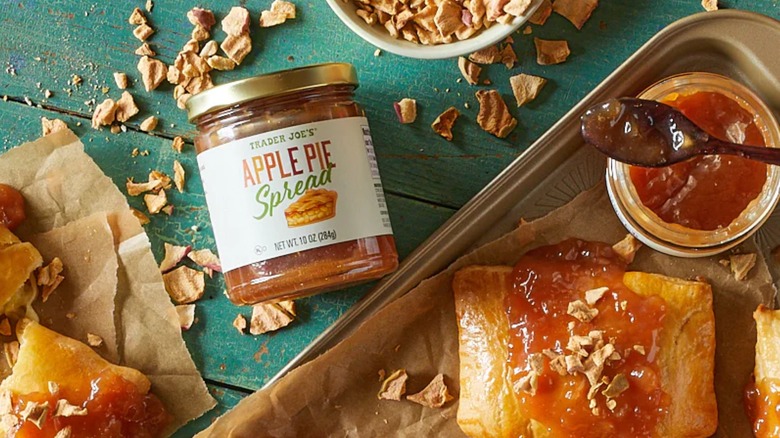 A jar of Trader Joe's Apple Pie Spread on table beside desserts