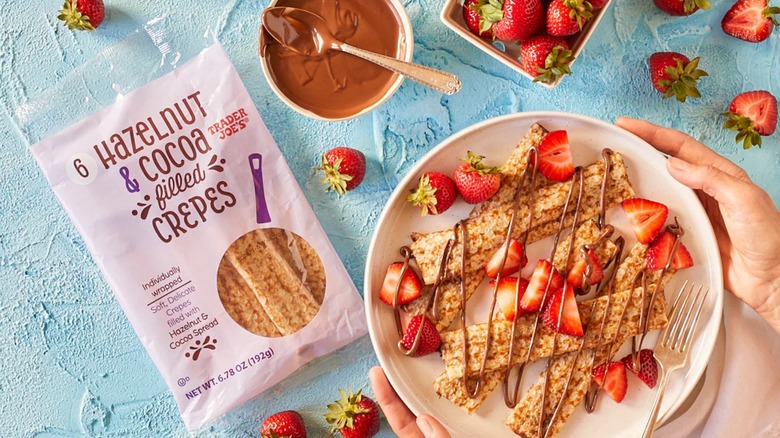 Trader Joe's Hazelnut & Cocoa crepes in their package and plated with chocolate drizzle and strawberries