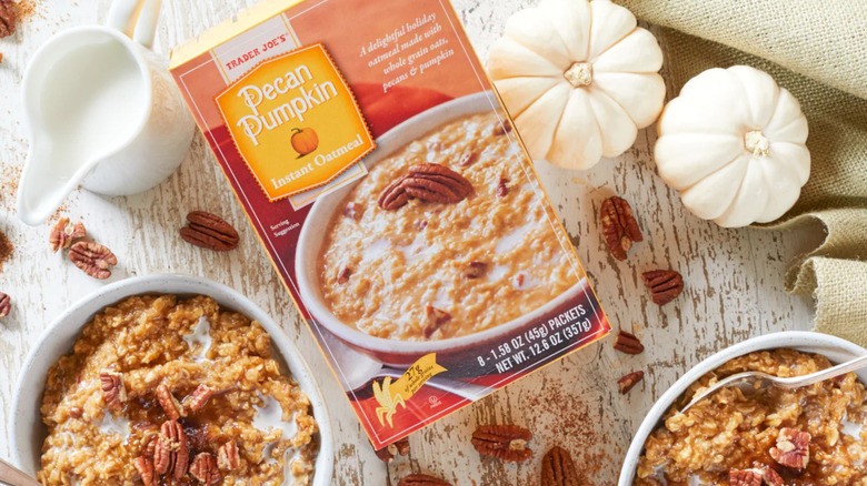 A package of Trader Joe's Pecan Pumpkin Instant Oatmeal on table beside bowls of oatmeal