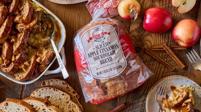 A loaf of Trader Joe's Apple Cinnamon Sourdough Bread and a table with festive fall dishes