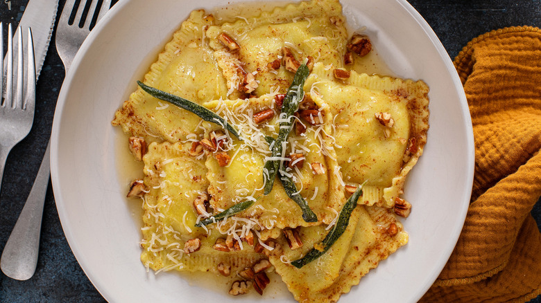 Ravioli sits in a brown butter sage sauce.