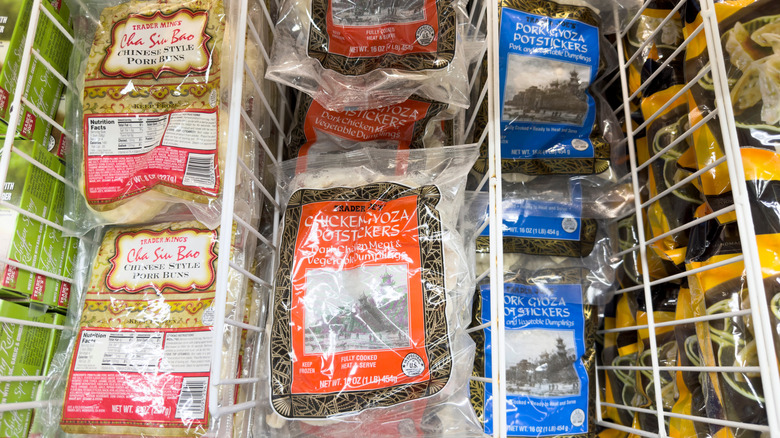 Bags of Trader Joe's chicken and pork gyoza in freezer