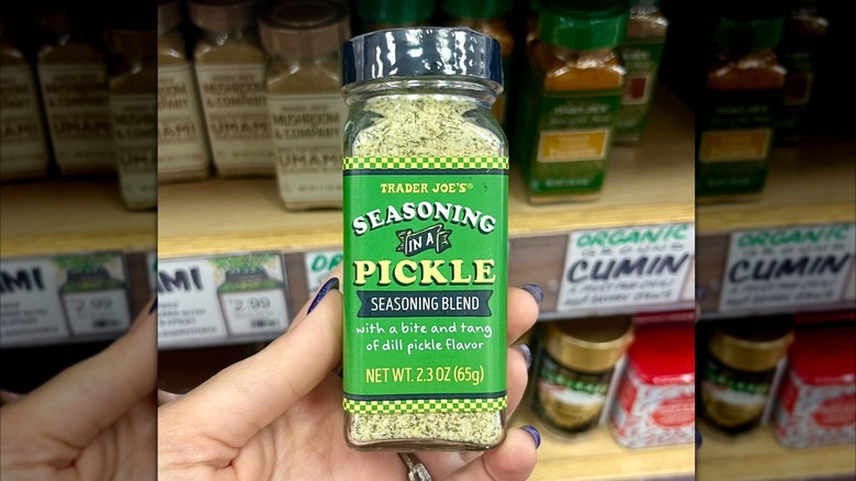 Hand holding bottle of Trader Joe's Seasoning in a Pickle blend