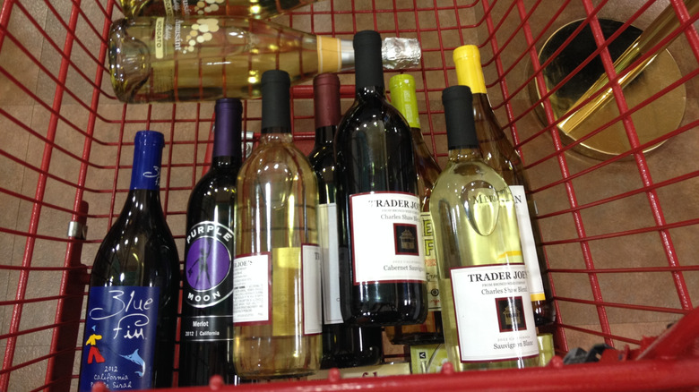 Bottles of wine in red shopping cart at Trader Joe's