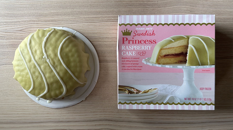 an overhead view of the Trader Joe's Swedish Princess Raspberry Cake beside its box