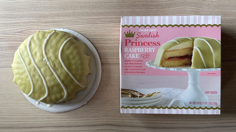an overhead view of the Trader Joe's Swedish Princess Raspberry Cake beside its box