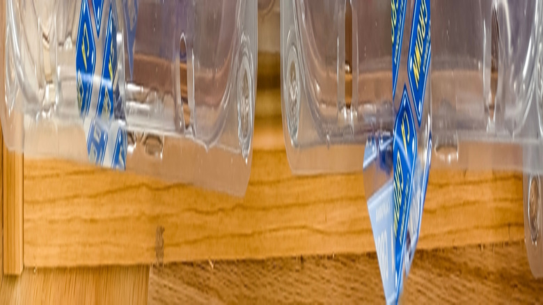 Plastic packages of cherry plums on Trader Joe's shelf.