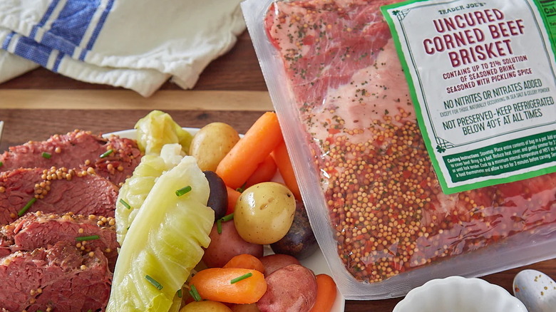 Slices of uncured corned beef brisket with vegetables and packaging