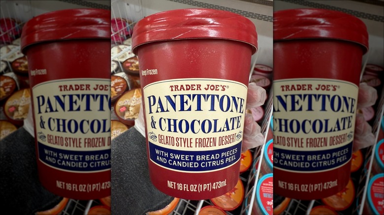 A person holding a pint of Trader Joe's Panettone & Chocolate Gelato-Style Frozen Dessert