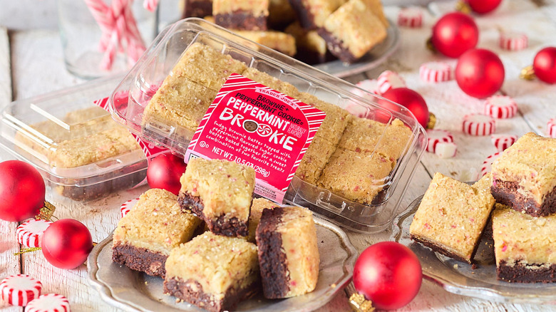 A plate of Trader Joe's Peppermint Brookies on a table next to a package and an array of holiday decorations