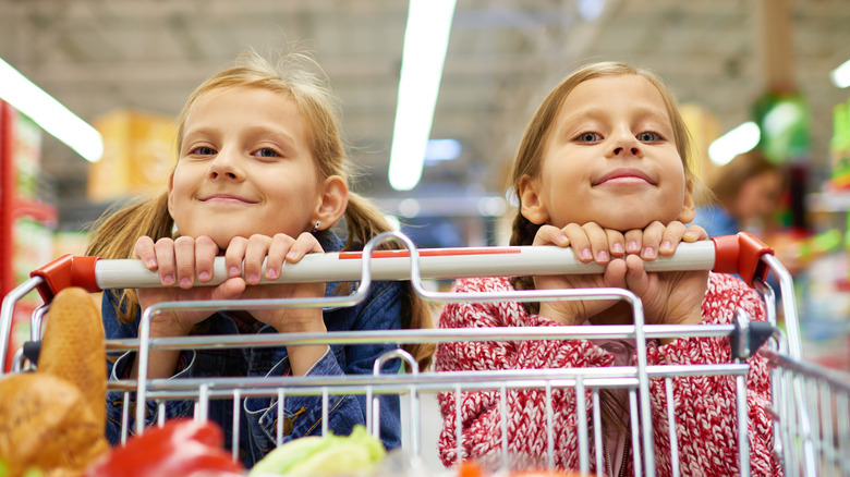 two little girls with shopping cart