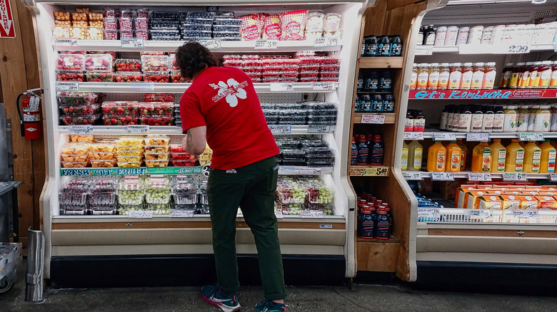 Trader Joe's employee in a store restocking food