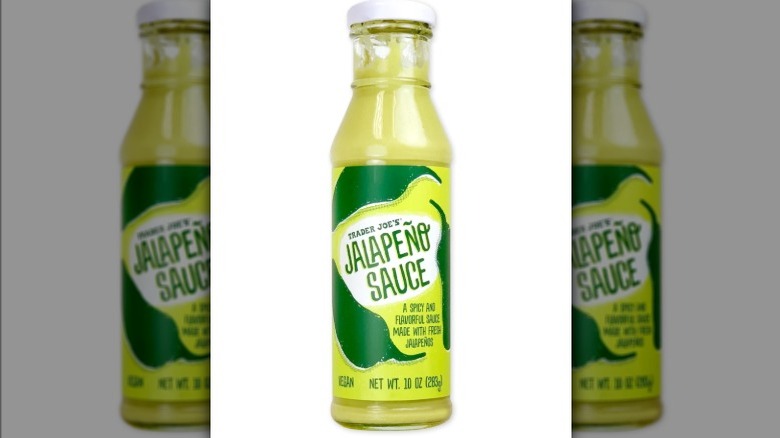 Jar of jalapeño sauce on white background