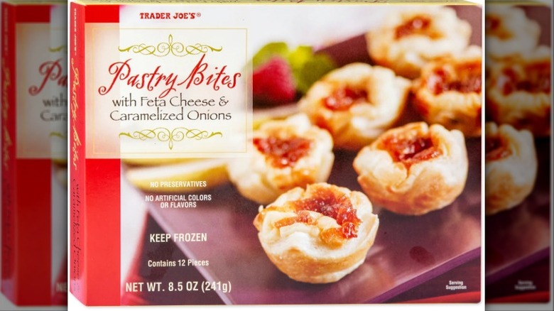 A box of Trader Joe's pastry bites with feta cheese and caramelized onions with the bites featured on the cover.