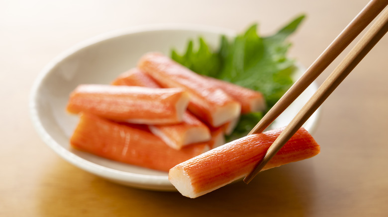 Imitation crab being picked up with chopsticks