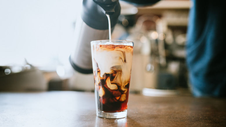 pouring milk into cold brew