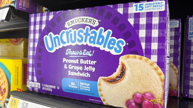 Uncrustables box in store with blue writing and bite taken out