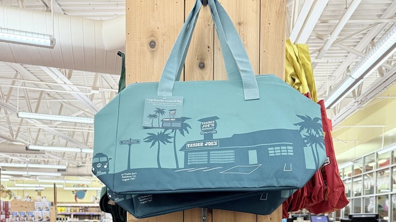 Trader Joe's Dusty Blue Large Insulated Bags hanging in a store