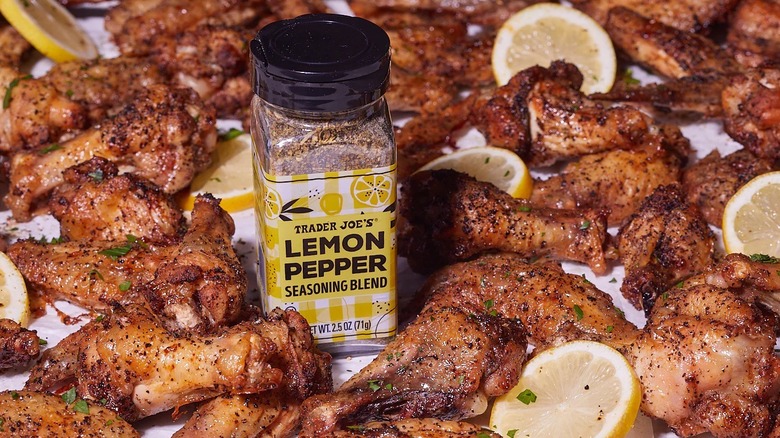 the new Trader Joe's Lemon Pepper Seasoning Blend surrounded by fresh sliced lemons and chicken wings