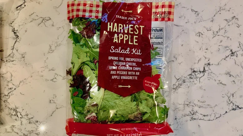 A bag of Trader Joe's Harvest Apple Salad Kit sitting on a kitchen counter