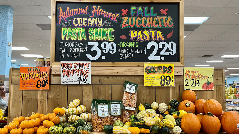 A special fall display of pumpkins, gourds, and pasta inside a Trader Joe's store