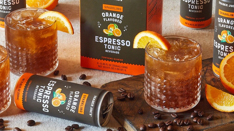 Sparkling Orange Flavored Espresso Tonic cans and drinks on a table