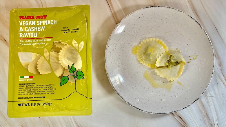 Trader Joe's Vegan Spinach & Cashew Ravioli on white plate next to package