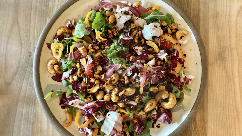 Salad with leaves, onion, cheese and nuts