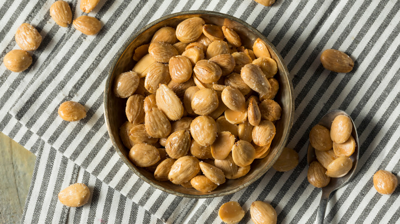 A bowl of Marcona almonds on a dining room table.