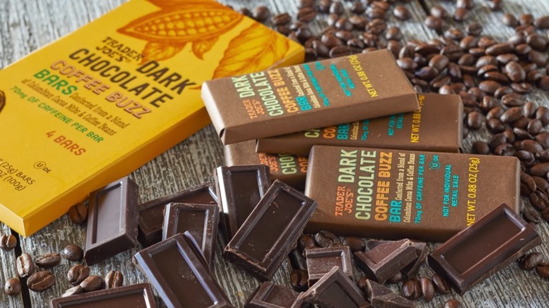 Trader Joe's dark chocolate coffee buzz bars and pieces of chocolate and coffee beans on table
