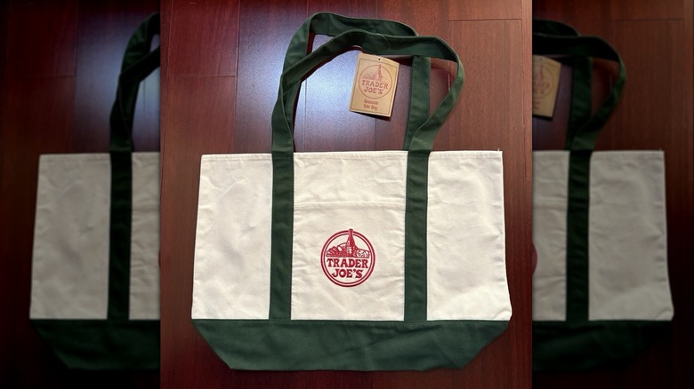 Dark green trimmed Trader Joe's white tote bag with red company logo