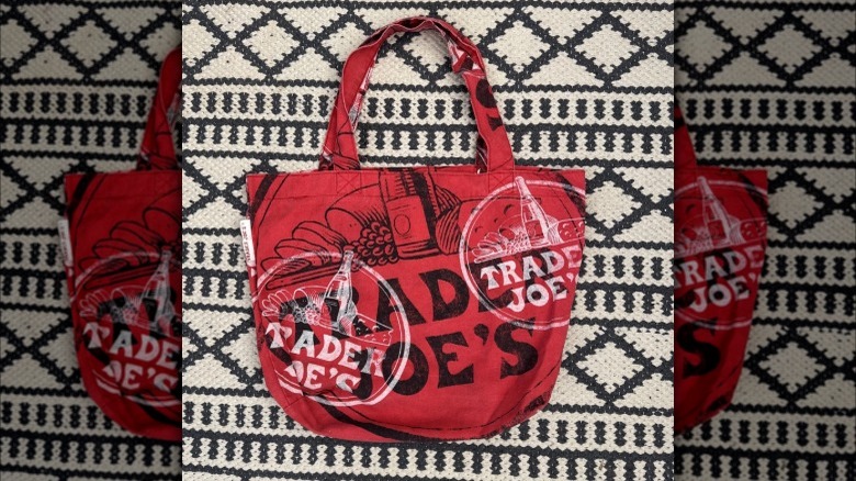 Red and maroon Trader Joe's tote bags next to each other