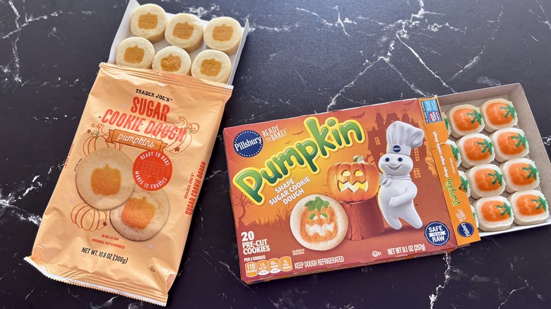 Trader Joe's and Pillsbury pumpkin sugar cookie dough packages with cookie sheets pulled out