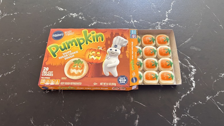 Pillsbury pumpkin shape cookie dough box with cookie sheet pulled out