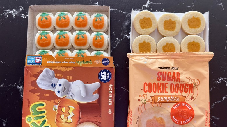 Pillsbury and Trader Joe's pumpkin sugar cookie dough packages with cookie sheets pulled out