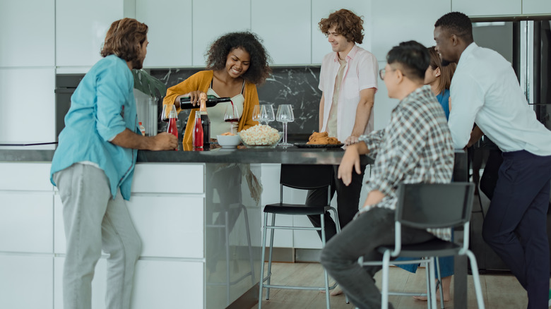 Friends using an extended kitchen island as a dining table