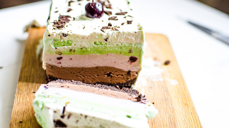 sliced spumoni cake on a wooden cutting board