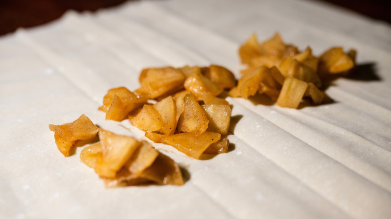 Sliced apples sitting on sheets of Phyllo dough