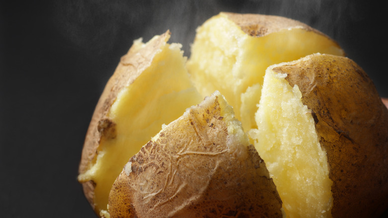 Baked potato sliced into four sections.