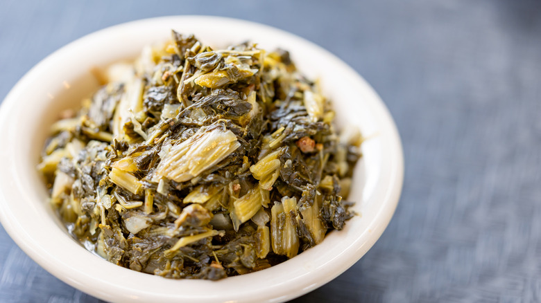 A bowl of collard greens on table